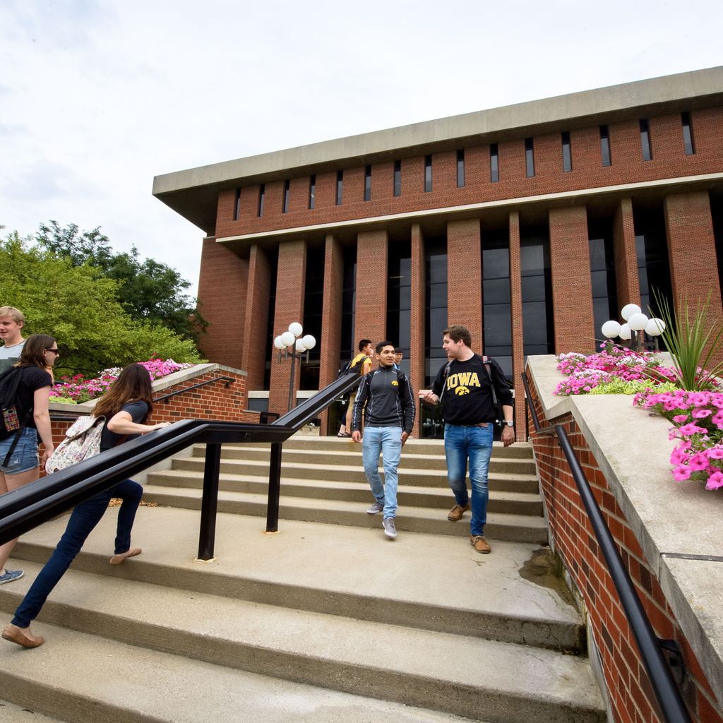 A group of students using the stairs in front of the main library