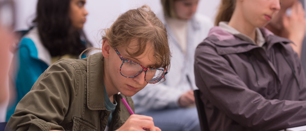 student studying at a desk and taking notes